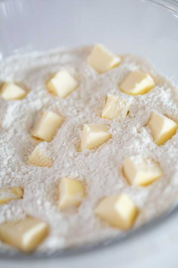 bowl filled with flour mixture and small cubes of butter