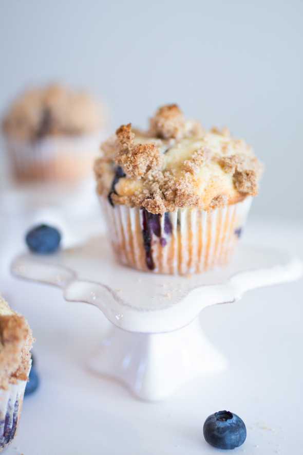 blueberry streusel muffin surrounded by fresh bluberries