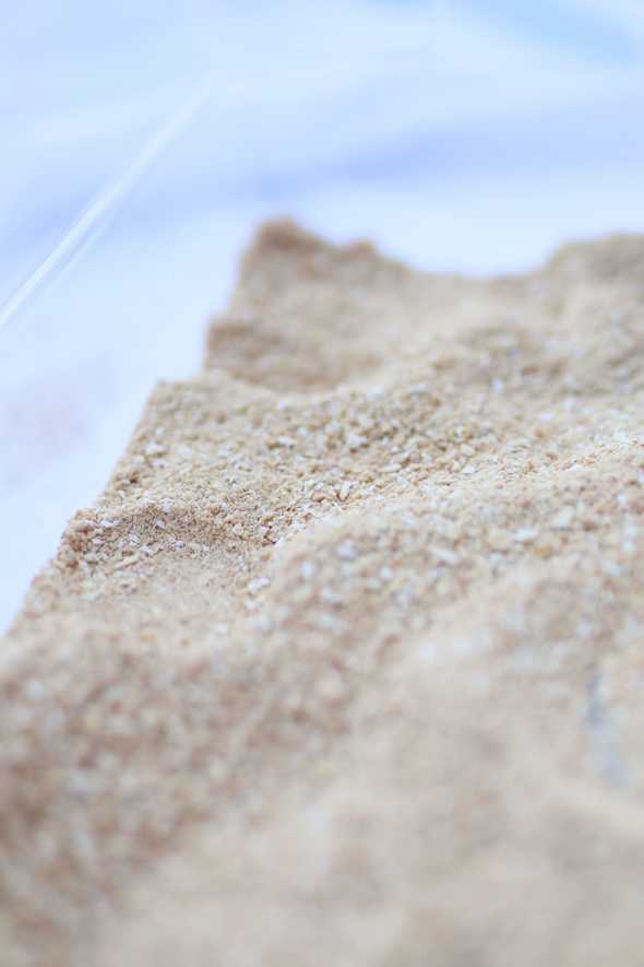 edible sand in a plastic tub