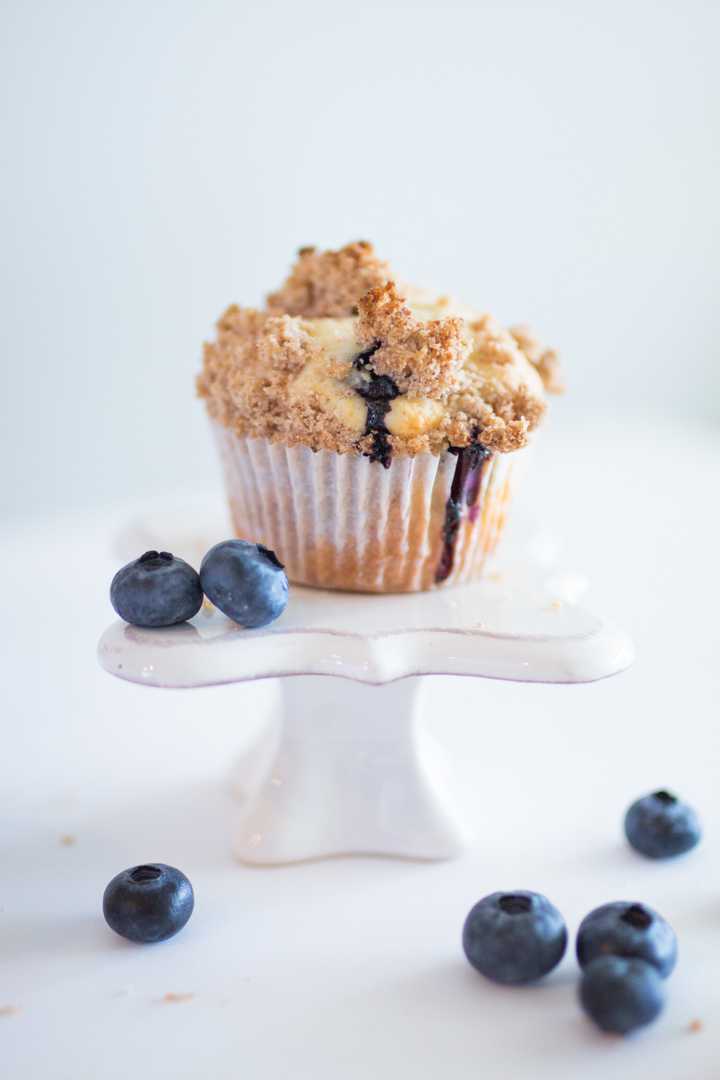 blueberry streusel muffin surrounded by fresh bluberries
