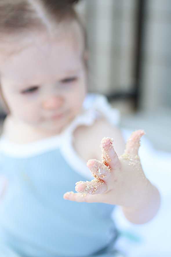 toddler hand covered in edible sand