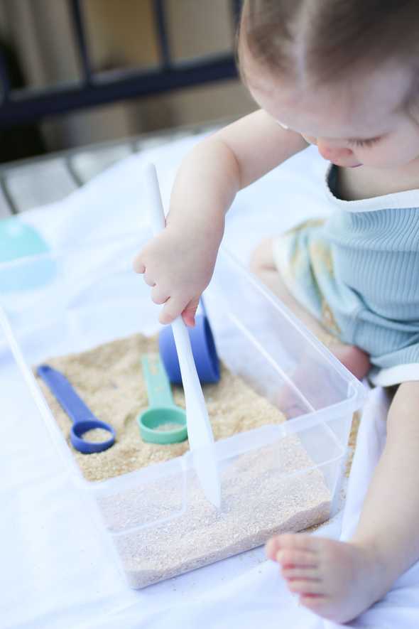 overhead shot of toddler playing in edible sand